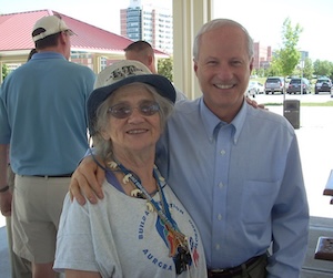 Mike Coffman posing with an Aurora woman.