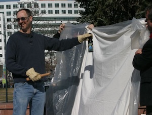 Ari prepares to smash a beer bottle.