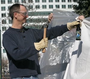 Ari prepares to smash a beer bottle.