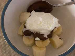 Sliced bananas with chocolate and whip cream.