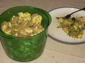 A dish featuring vegetables, quinoa, and olive oil, on a plate and in a large plastic bowl.