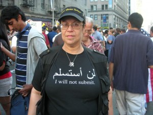 A woman wears a shirt that reads I will not submit.