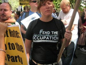 A woman wears a shirt reading End the Occupation campaign to end the Israeli occupation.