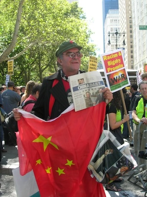 A man holding a Communist China flag.