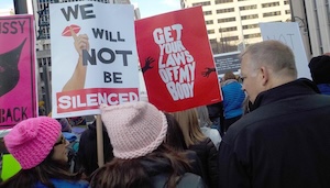People hold signs including one reading Get your laws off my body.