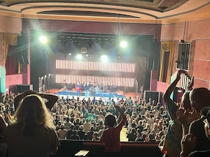 Sparks concert, Boulder, July 2023, showing, facing the stage, a lighted room and a cheering crowd