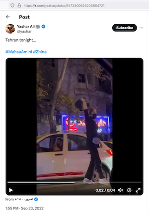 An Iranian woman defiantly waves a hijab in the air.